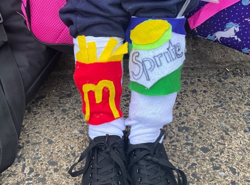 Socks decorated with felt decorations to look like McDonald's fries and a Sprite can