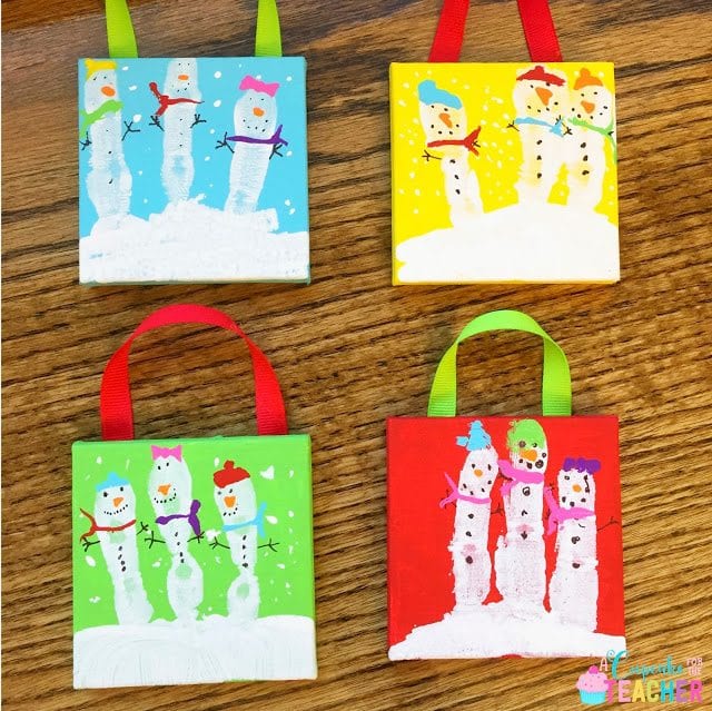 Finger paint snow people on tiles as example of winter crafts for the classroom.