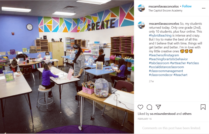 Students in a colorful art classroom with desks in socially-distanced seating arrangements