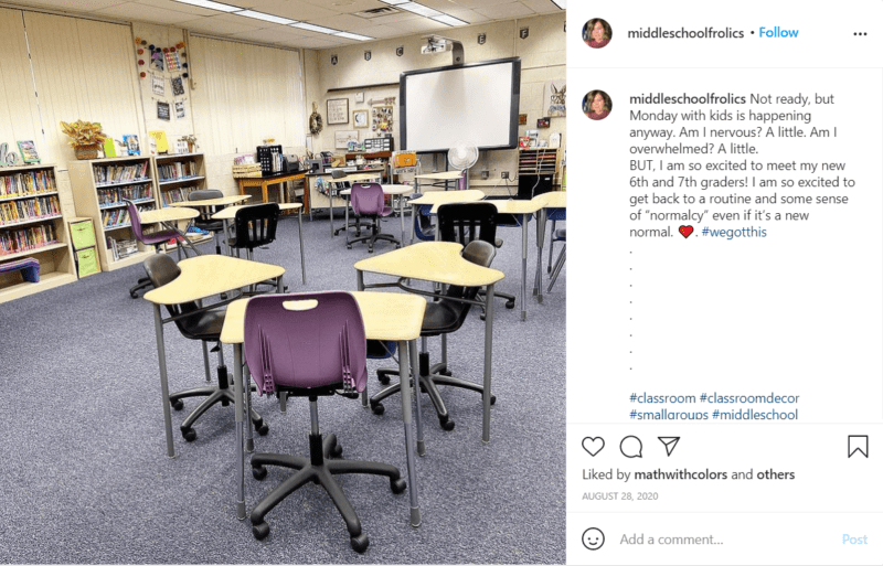 Middle school classroom light colored desks arranged in groups of three with grey carpet 