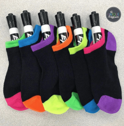 dry erase board markers are stored in socks. 