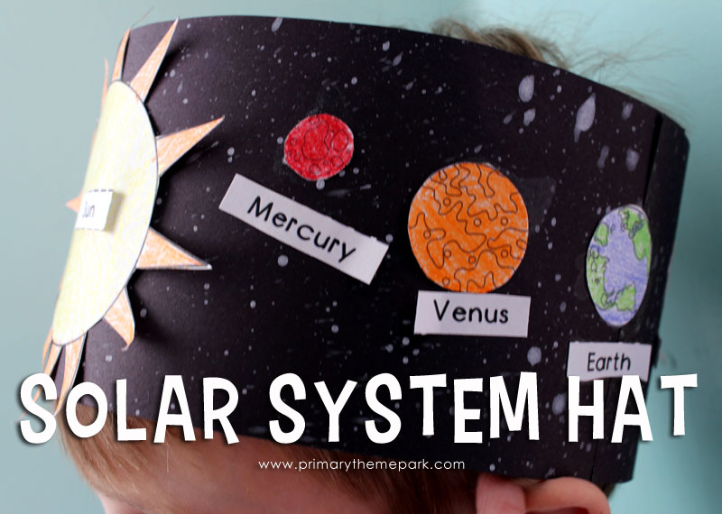 The top part of a child's head is shown wearing a homemade headband that has the sun and planets on it (solar system projects)