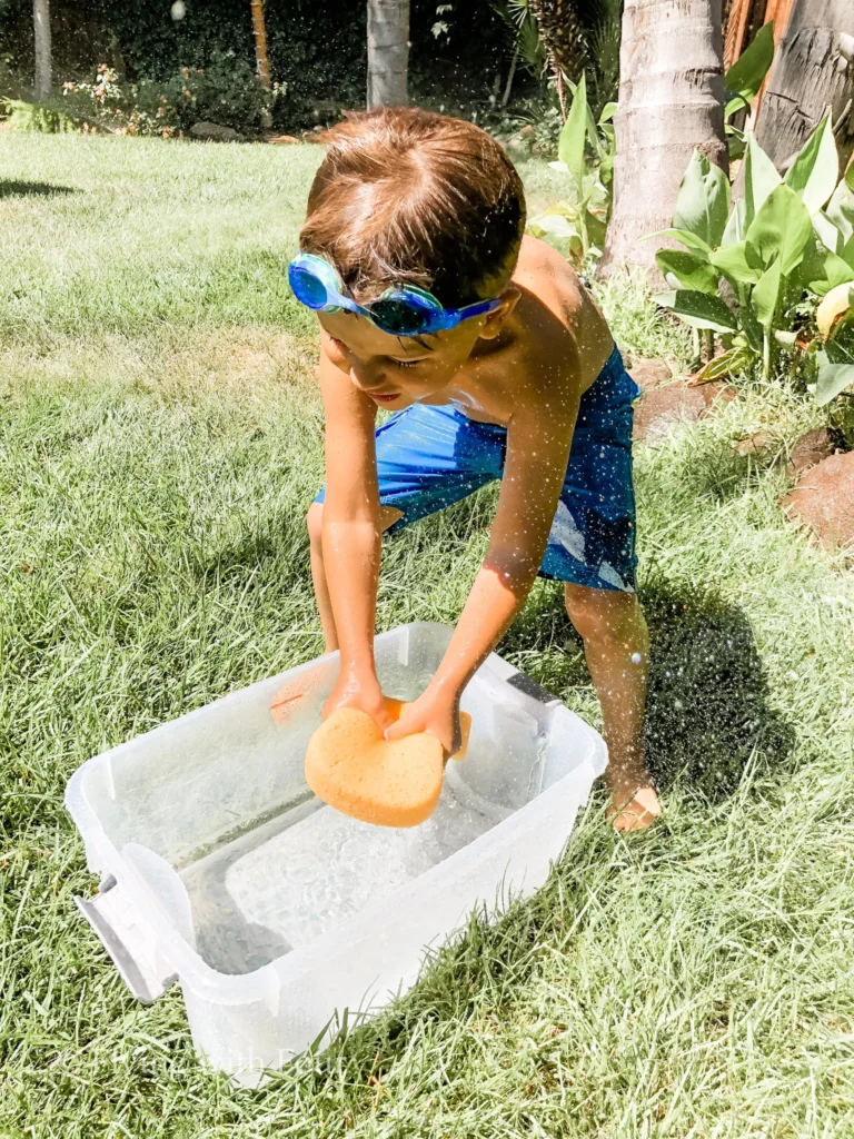photo-of-kid-playing-with-sponge-and-water