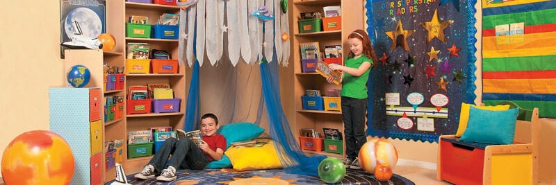 Brightly colored space-themed classroom library nook decorated with space theme