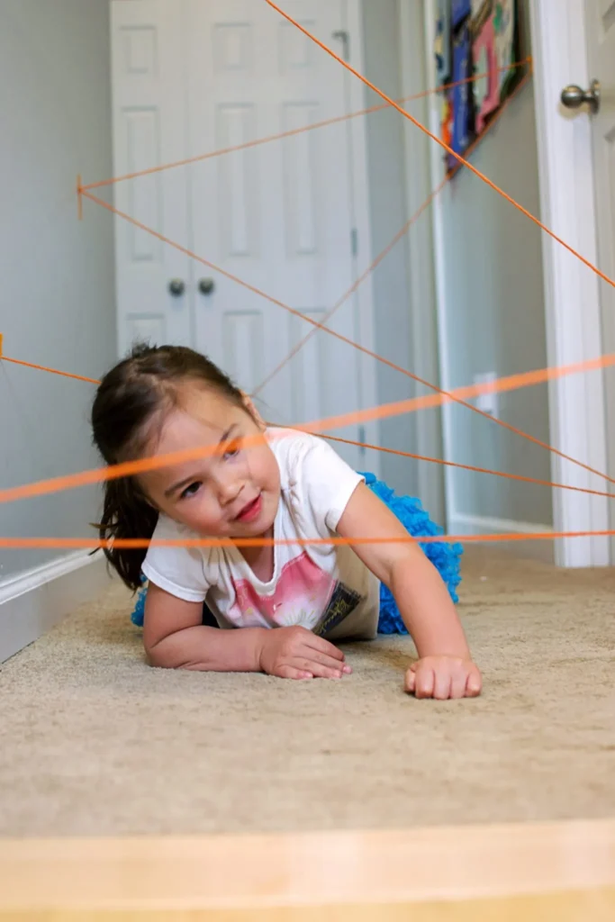 photo-of-child-crawling-through-spider-web-activity
