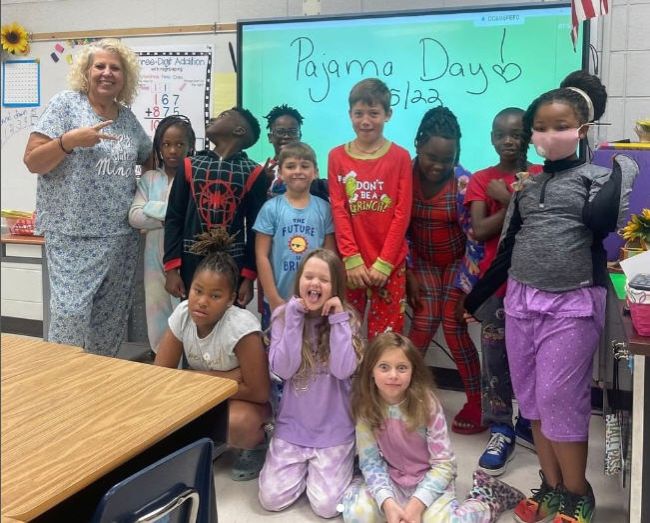 Students and teacher dressed up for school pajama day