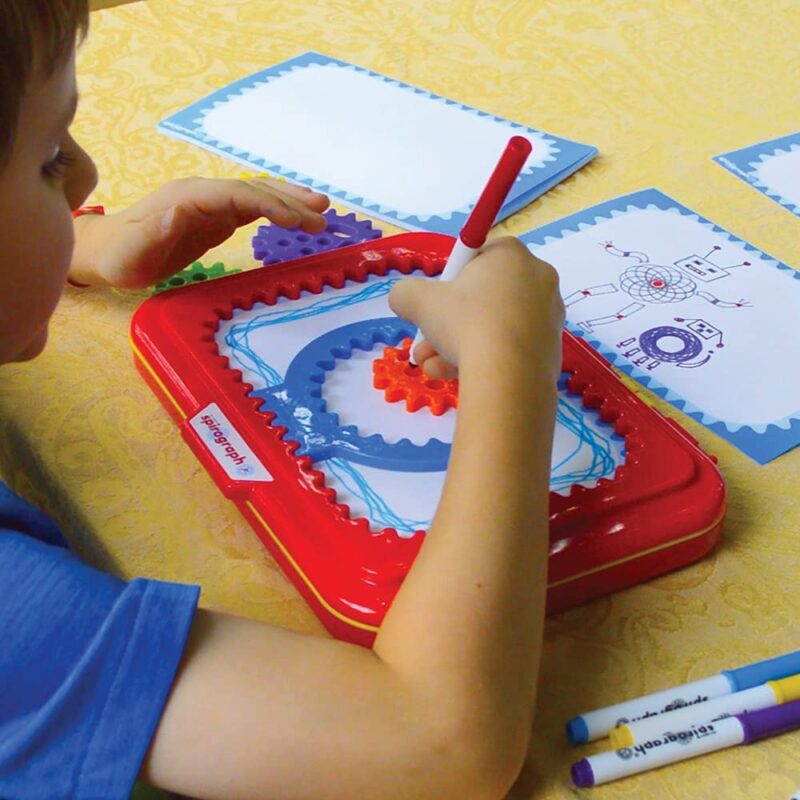 Young boy playing with a Spirograph