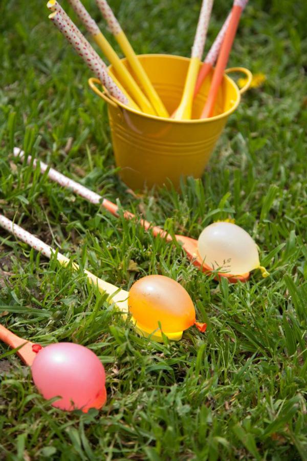 spoons on grass with water balloons for a water activity 