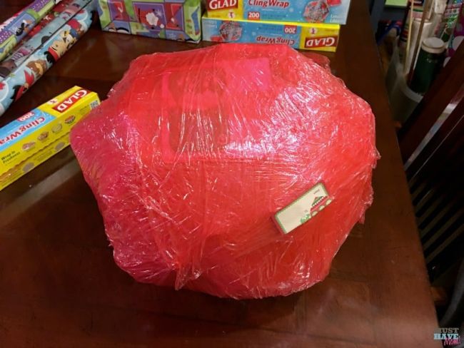 Large ball of red saran wrap with gifts inside (Staff party games)