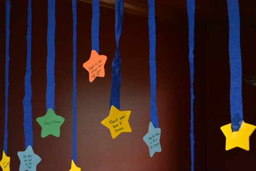 Paper stars with actions hanging from ceiling.