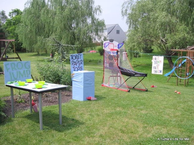 Backyard carnival with games like frog jump, toilet paper toss, and basketball (Staycation Activities)
