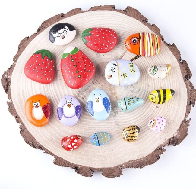 Collection of rocks painted like strawberries, fish, birds, and more (Spring Break Activities)