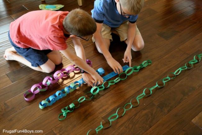 Two students measuring paper chains