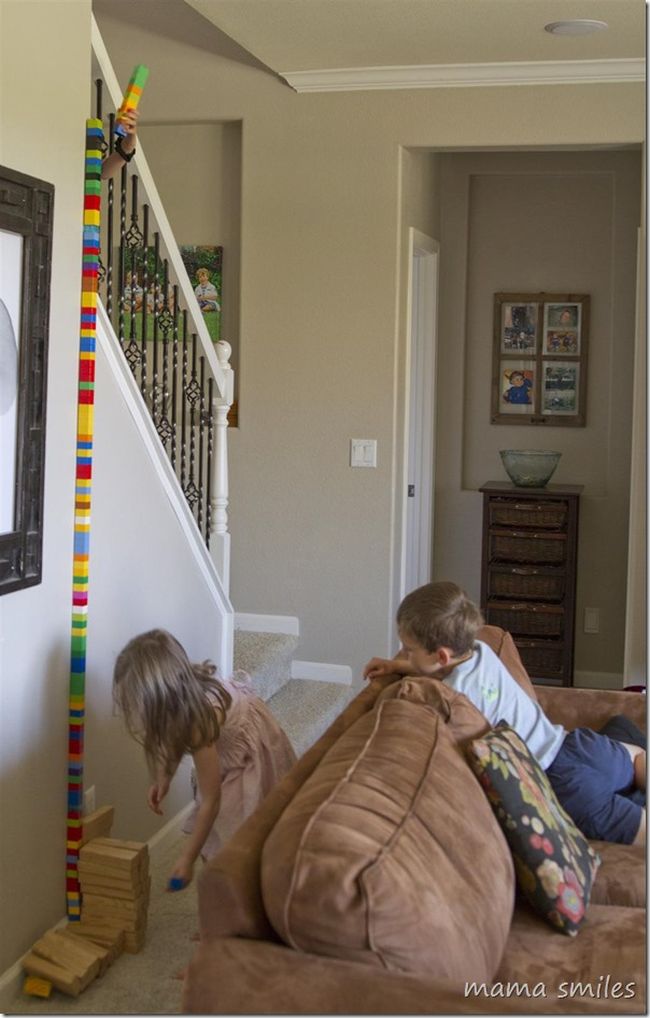 Children building a tower to the ceiling using building blocks