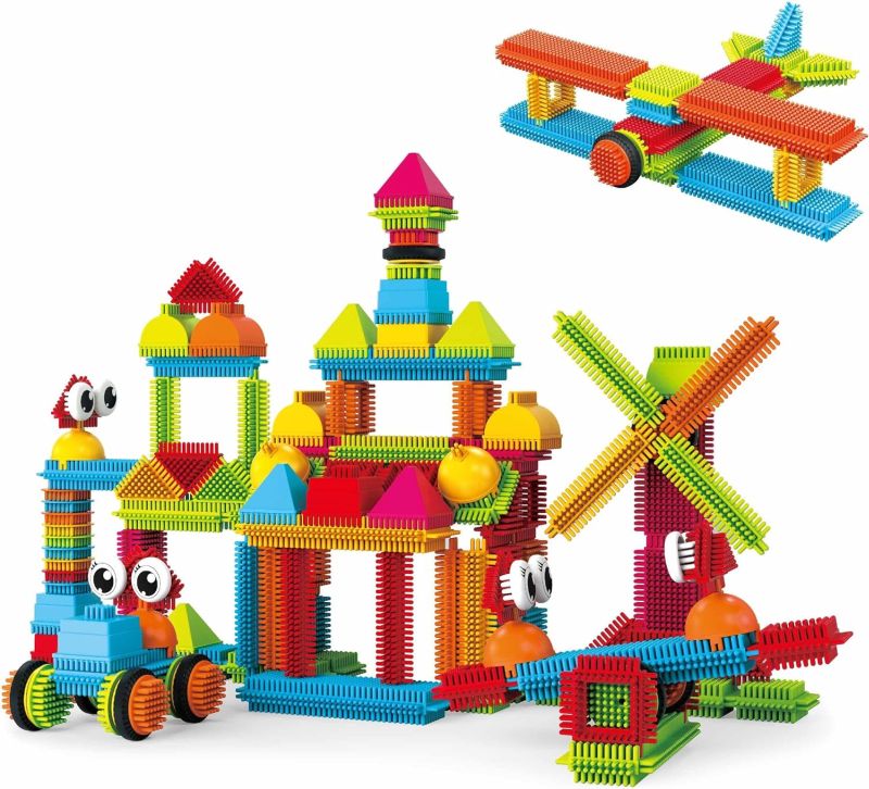 Colorful bristle block building toys used to create a house, windmill, plane, and more