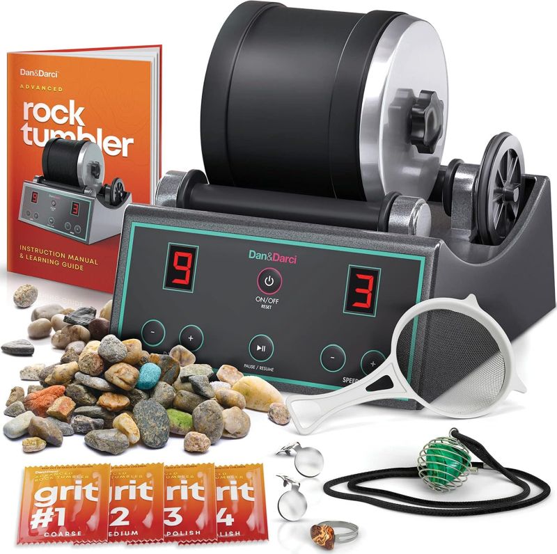Rock tumbler with rough and polished rocks, polishing media, and instruction book