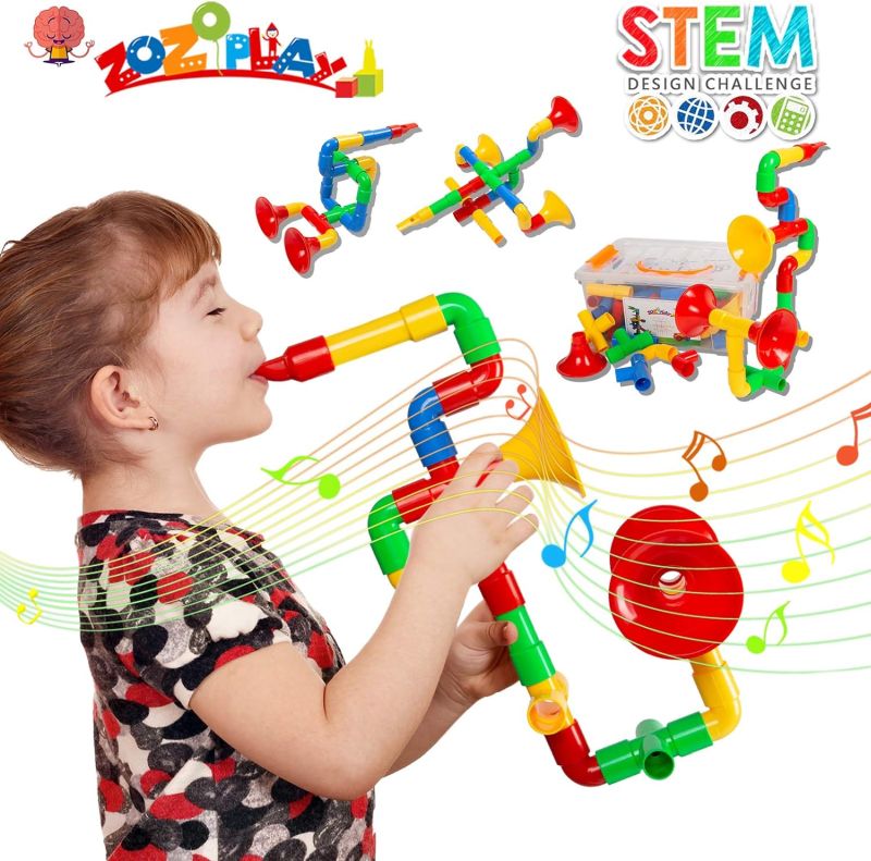 Child playing with a unique musical instrument made from interlocking tubes and whistles