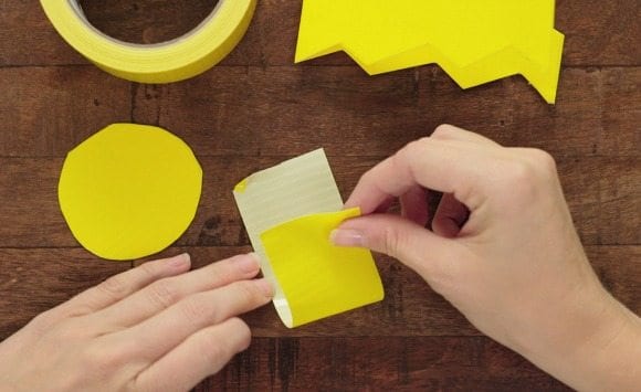 Fold a piece of yellow tape together.