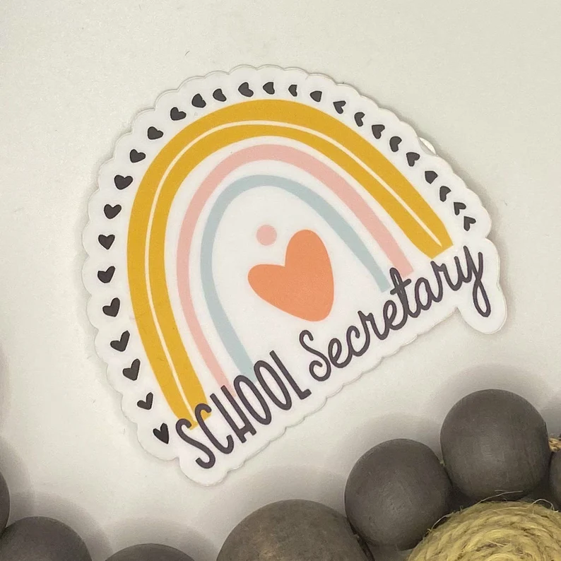 A sticker has a rainbow and heart on it and it says "school secretary" as an example of gifts for paraprofessionals