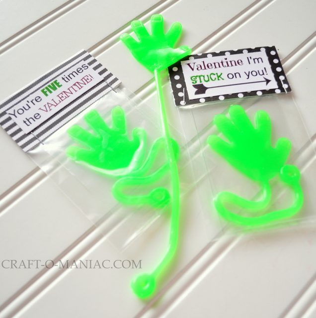 Two cellophane packets with bright green "sticky hand" toys inside as an example of valentines for students