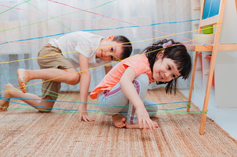 Children climbing through string- summer activities for kids
