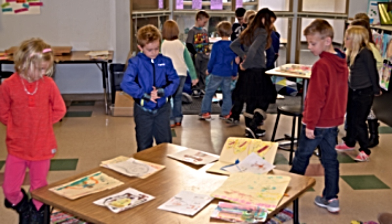 students doing a "gallery walk" around the classroom