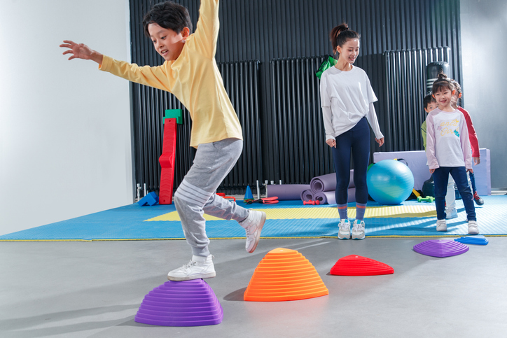 Kids doing an obstacle course in the school gym