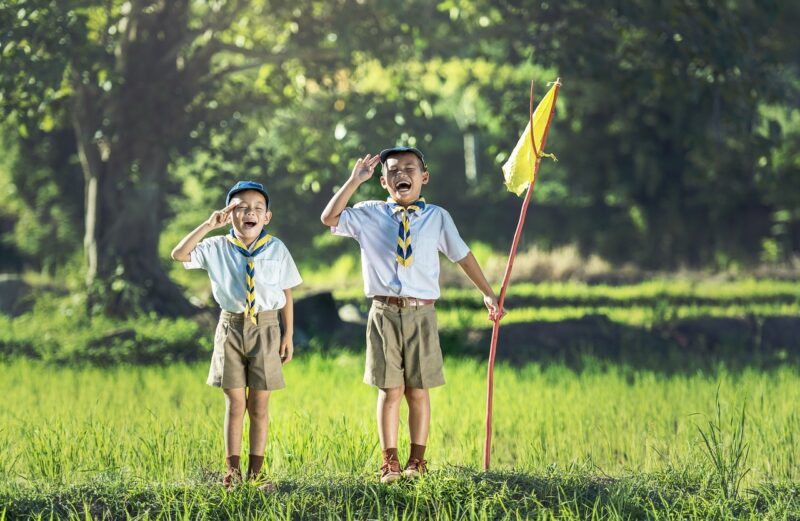 two boys saluting at summer camp 