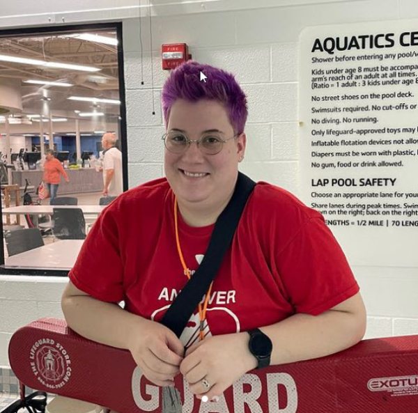 YMCA lifeguard posing with float at a pool (Summer Jobs for Teachers)