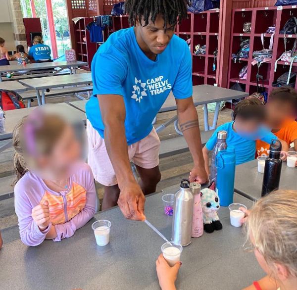 Teacher supervising a science experiment at a summer STEM camp