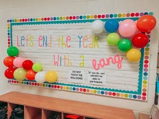 Welcome sign with balloons reading "End the year with a bang"