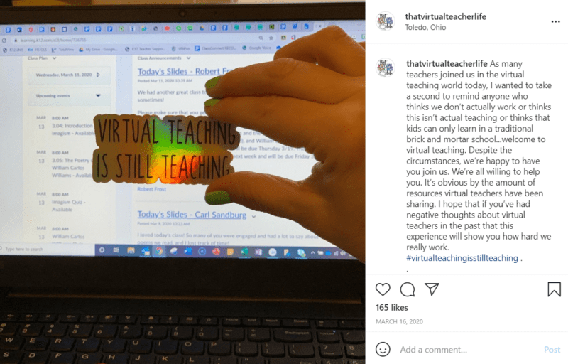 Sticker that says "Virtual Teaching Is Still Teaching" being held by a hand in front of a laptop screen