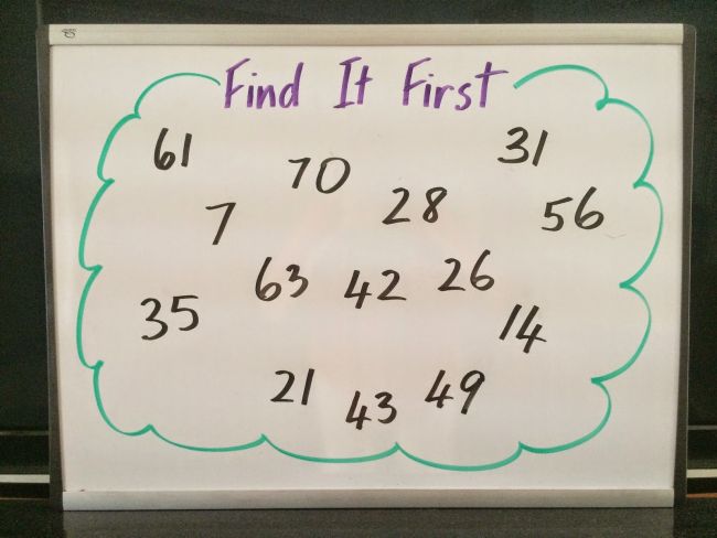 Random numbers written on a whiteboard, labeled "Find It First"