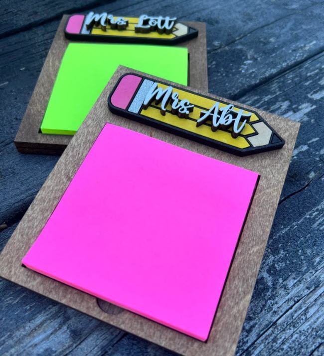 Wooden sticky note holders with teacher's name printed on a wooden pencil on top, used as teacher appreciation gifts