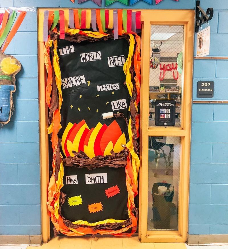 Classroom door decorated with a campfire and marshmallows. Text reads "We need s'more teachers like you."