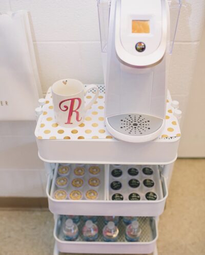 A white cart set up as a classroom coffee station