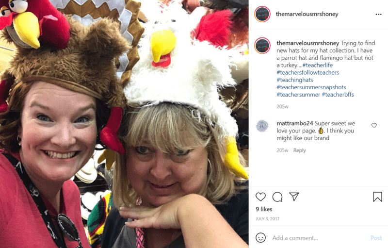 Two teachers make silly faces while posing in turkey and chicken hats