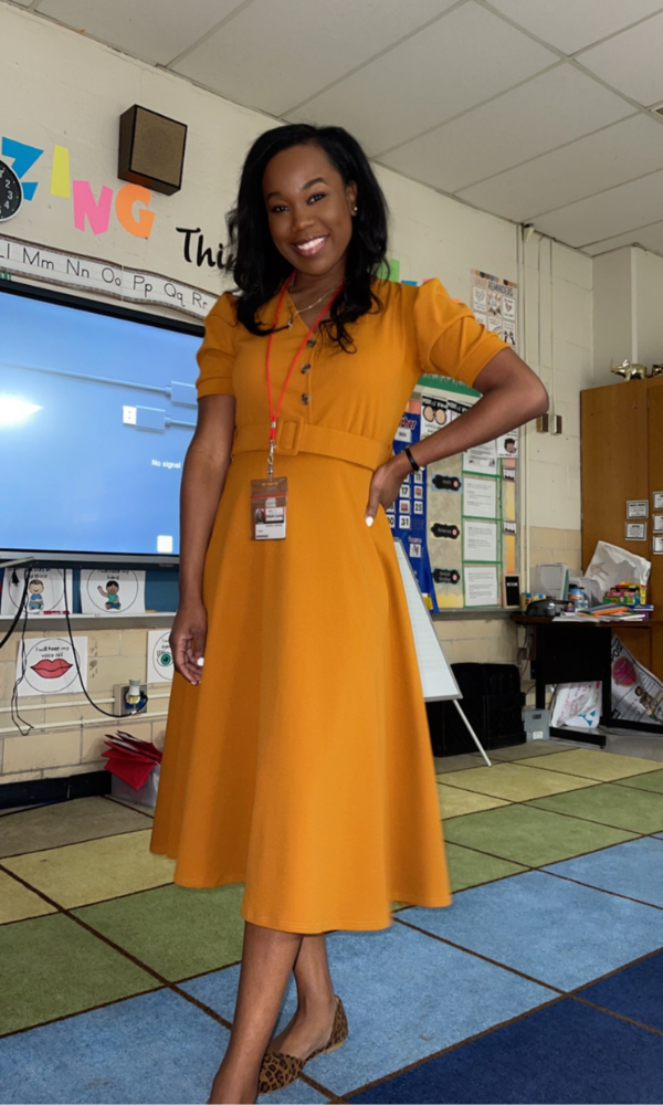 Teacher wears the yellow dress from her teacher gift