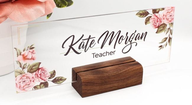 Clear acrylic name sign with floral decoration in the corners, mounted on a block of wood (Teacher Name Signs)