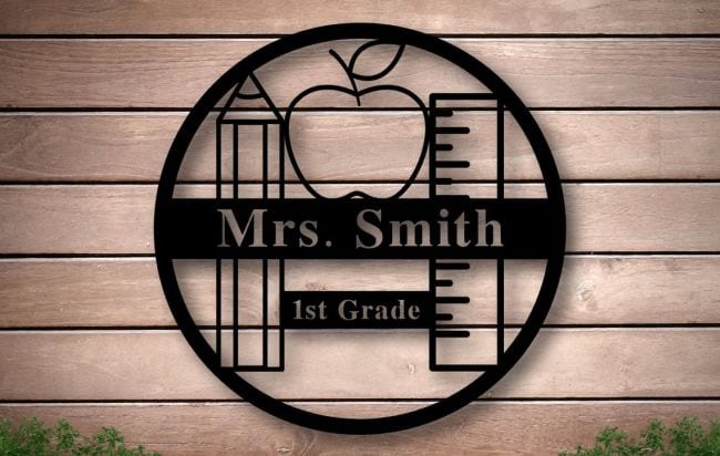 Metal laser cut sign in the shape of a circle with ruler, pencil, apple, and teacher name (Teacher Name Signs)