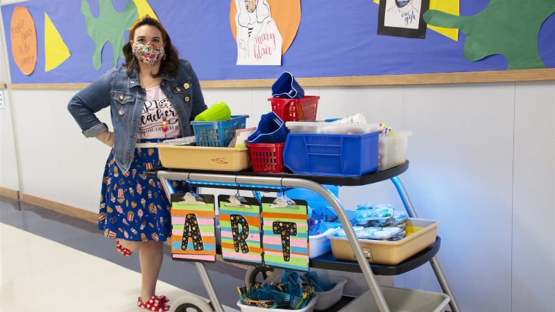 art teacher posing with her portable supply cart
