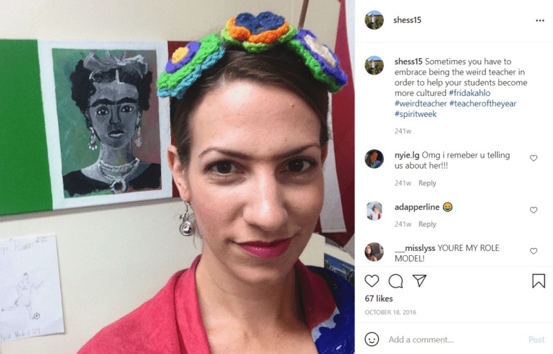 Closeup of the face of a teacher dressed as Frida Kahlo while standing in front of a rendering of Frida Kahlo's famous self portrait