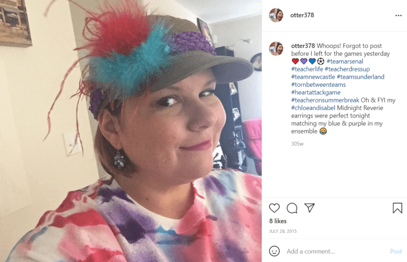 Closeup of a teacher's face wearing a hat with colored feathers celebrating school spirit day