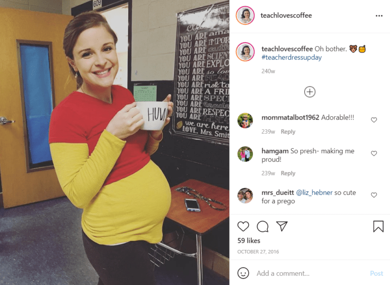 Pregnant teacher using her baby bump to create a Winnie the Pooh costume, holding a mug that says "Hunny" in a classroom
