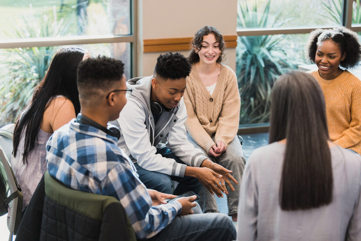 teens sitting in a circle making small talk