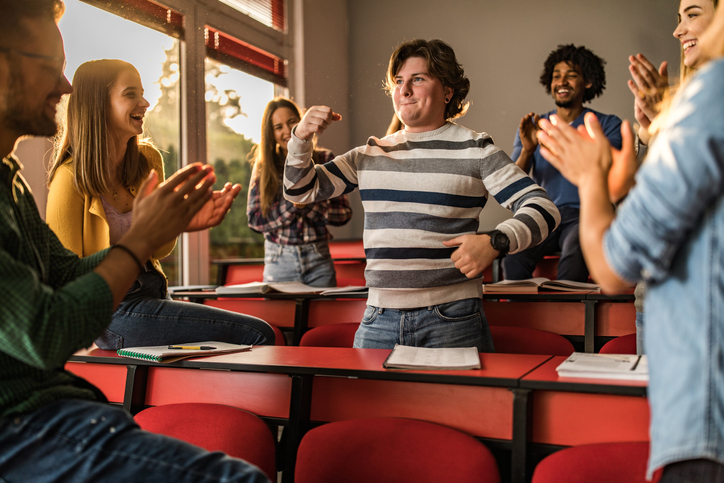 Teenagers having fun dancing in a classroom 