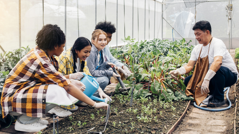 students learn the job readiness skill of responsibility as they work in a garden with their teacher