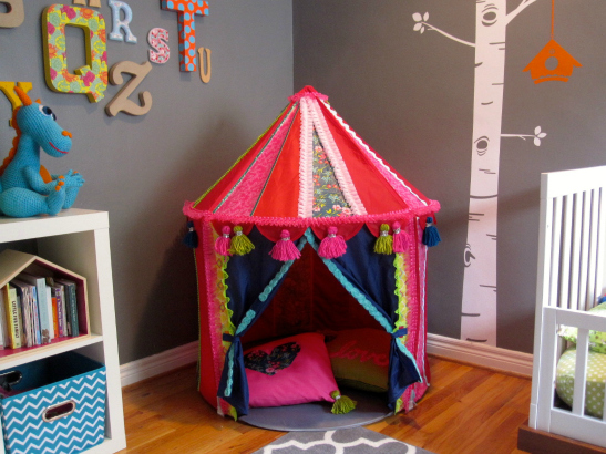 A toy circus tent that has been spruced up is shown in a play area.