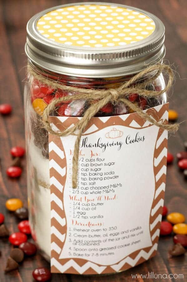 mason jar with cookie mix ingredients and recipe on the side for a thanksgiving gift for teachers 