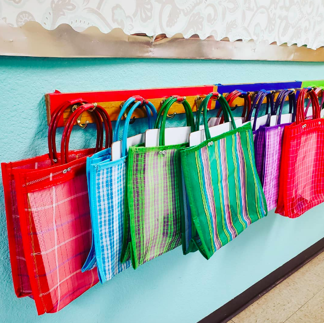 Colorful mesh bags hold student dry erase boards